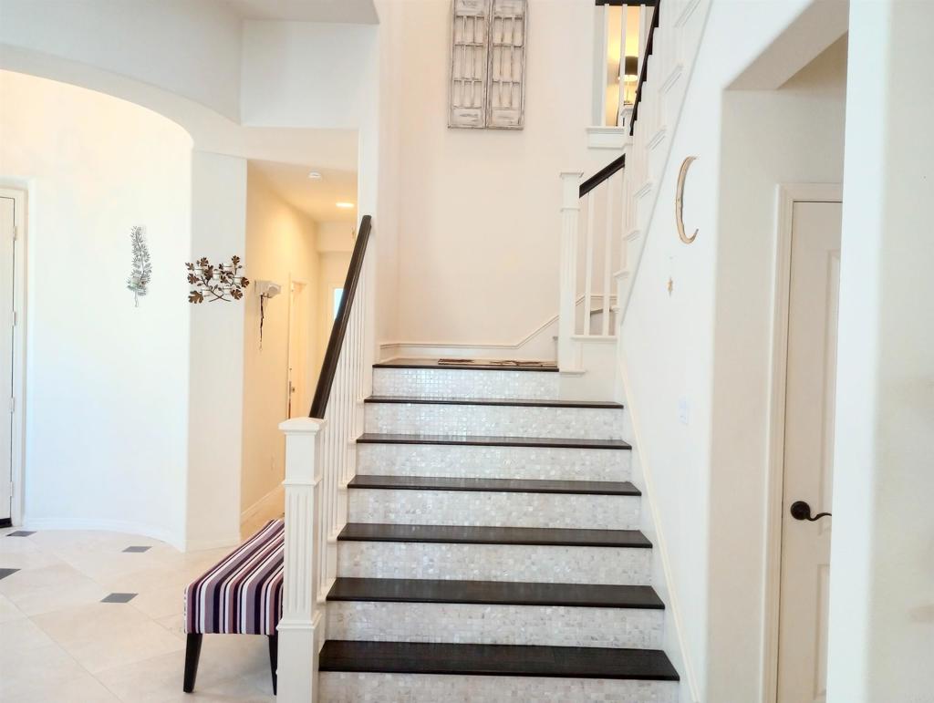 5544 Mill Creek Road San Diego, CA 92130 - Photo 11 of 54 a view of staircase with white walls and a window