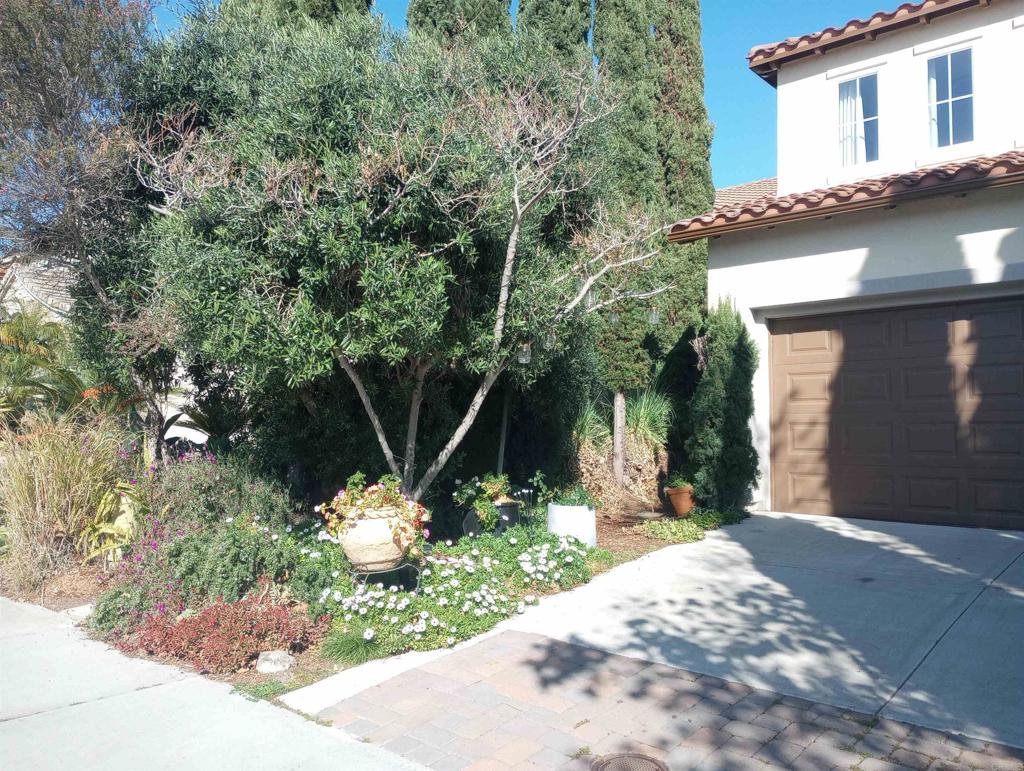 5544 Mill Creek Road San Diego, CA 92130 - Photo 15 of 54 a front view of a house with a yard and a garage