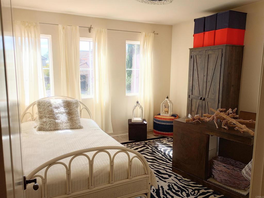 5544 Mill Creek Road San Diego, CA 92130 - Photo 29 of 54 a bedroom with a bed and wooden floor