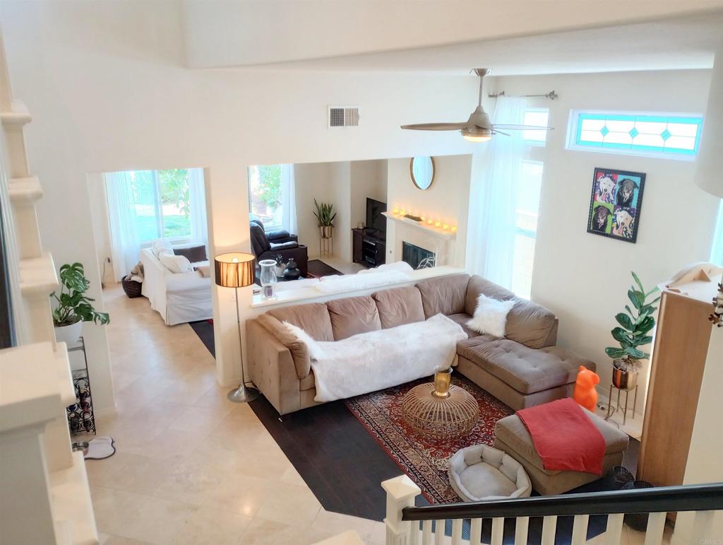 5544 Mill Creek Road San Diego, CA 92130 - Photo 3 of 54 a living room with furniture and a chandelier