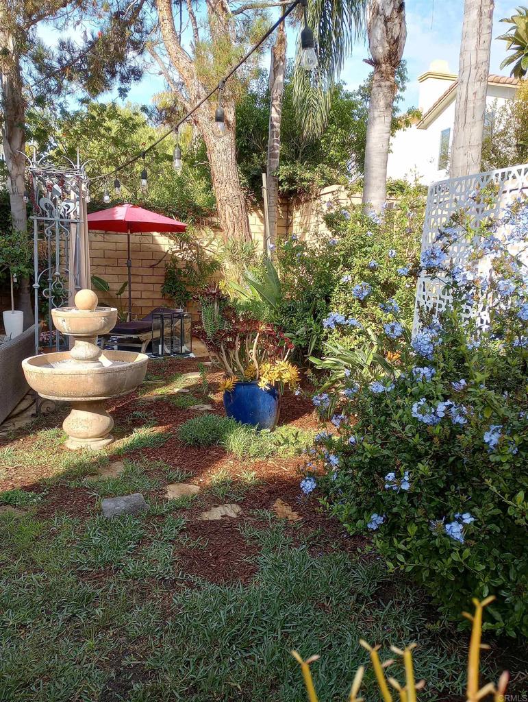 5544 Mill Creek Road San Diego, CA 92130 - Photo 38 of 54 a backyard of a house with table and chairs