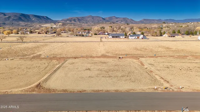 a view of a house with pool and a yard