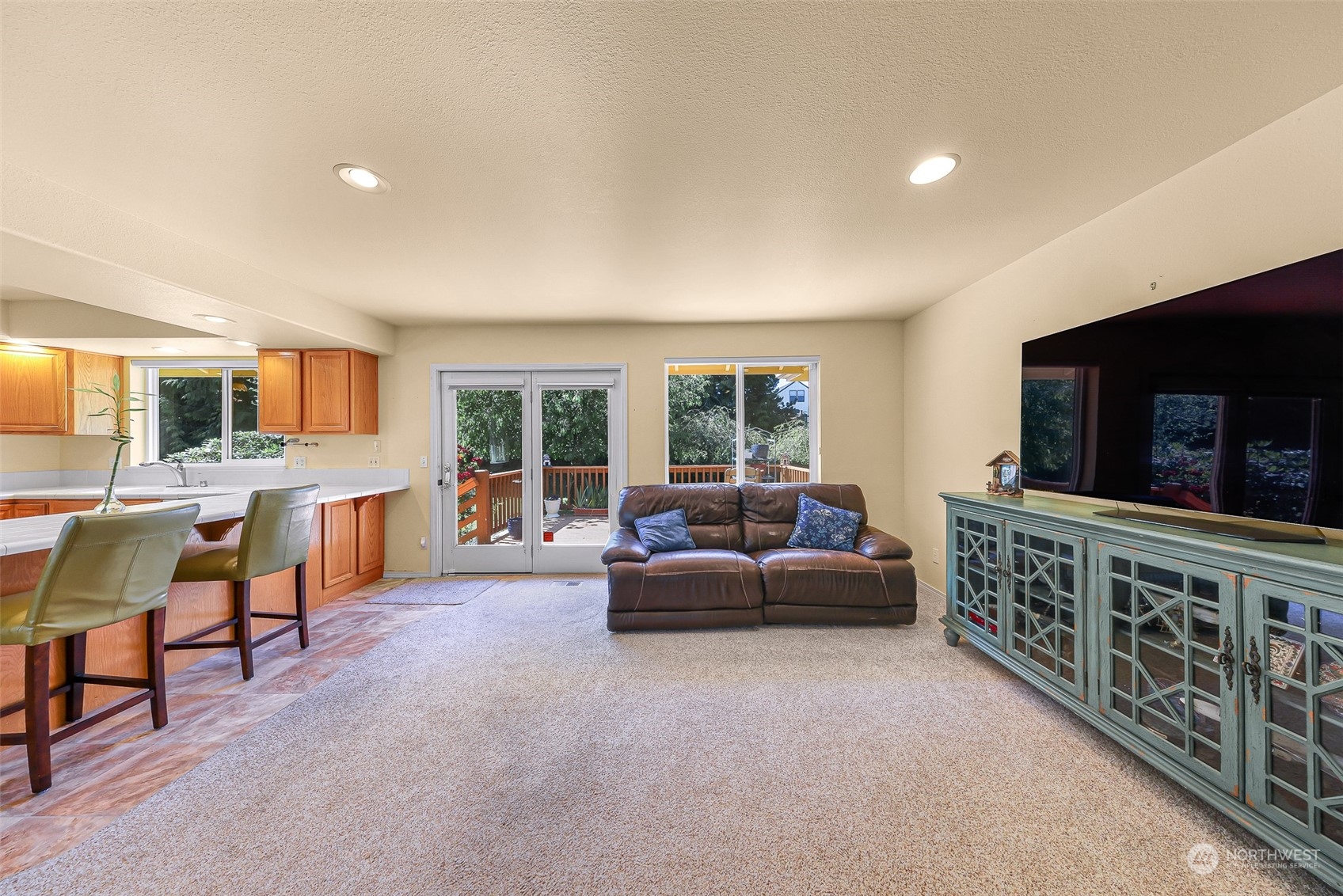 3827 Copper Pond Anacortes, WA 98221 - Photo 11 of 26 a living room with furniture a flat screen tv and a window