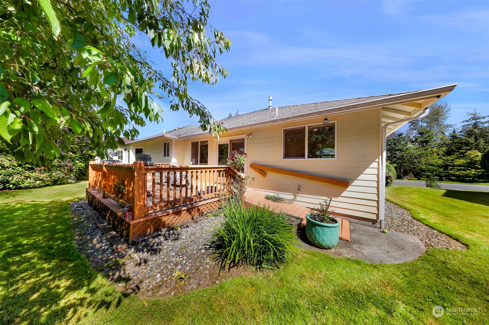 3827 Copper Pond Anacortes, WA 98221 - Photo 23 of 26 a white bench sitting in front of a house with a yard
