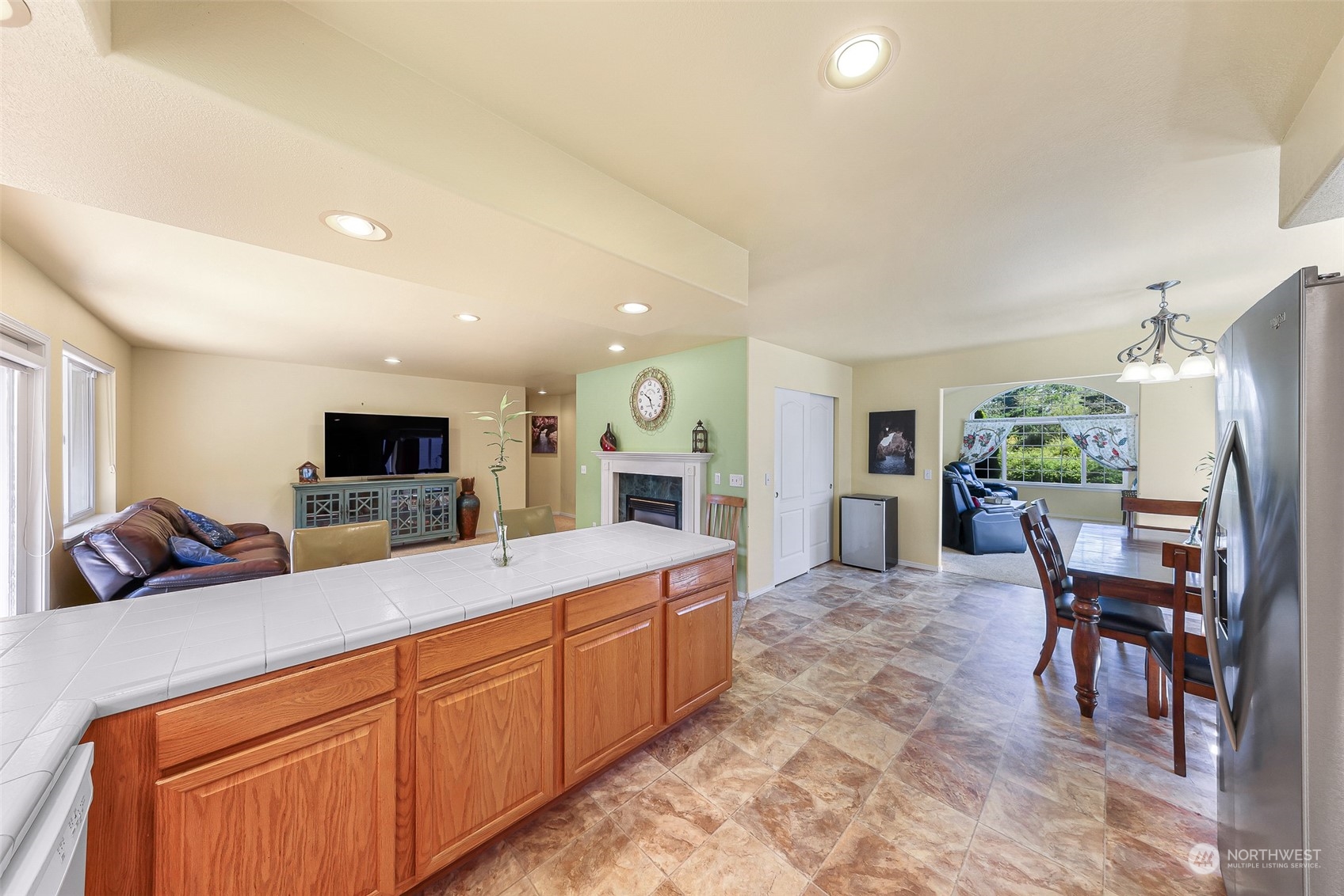 3827 Copper Pond Anacortes, WA 98221 - Photo 7 of 26 a large living room with stainless steel appliances granite countertop furniture a fireplace and a flat screen tv