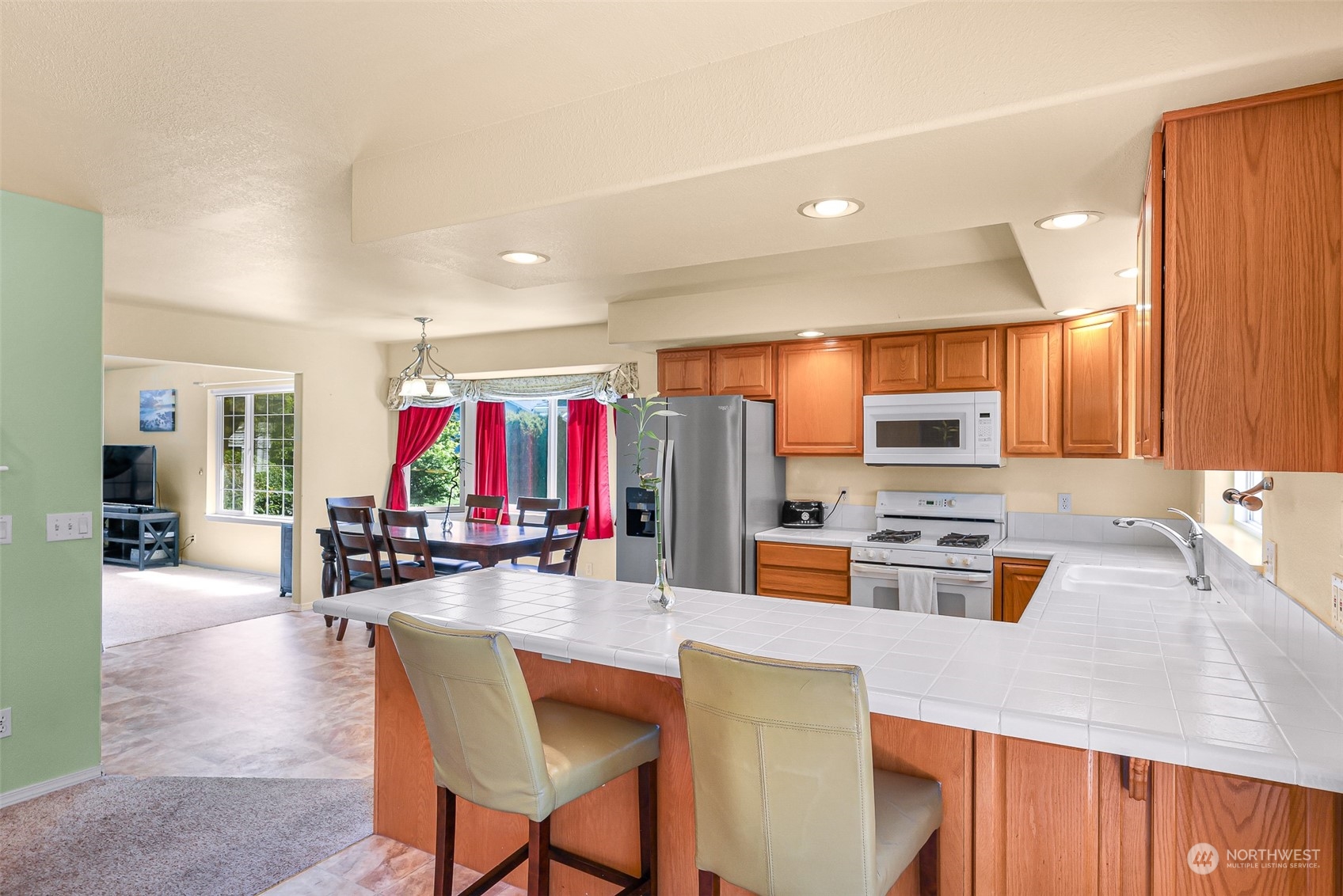3827 Copper Pond Anacortes, WA 98221 - Photo 8 of 26 a kitchen with lots of counter top space and living room
