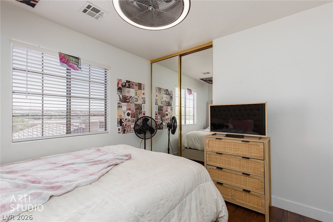 387 Silver Road Mesquite, NV 89027 - Photo 24 of 46 Hardwood floors and sliding mirrored closet doors accent this comfortable secondary bedroom.