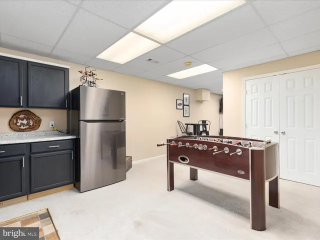 a front view of a house with swimming pool and green space