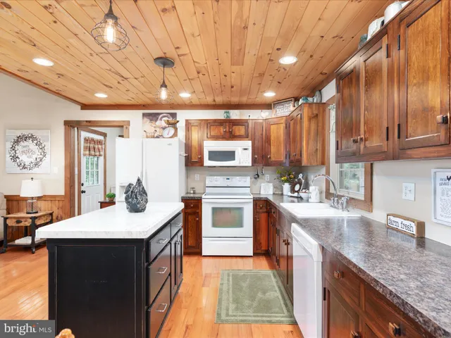 a view of a hallway with bathroom and wooden floor