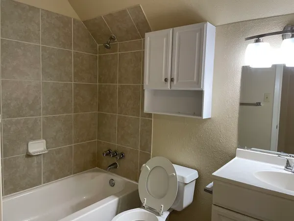a bathroom with a toilet and a bathtub