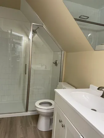 a bathroom with a toilet sink and shower