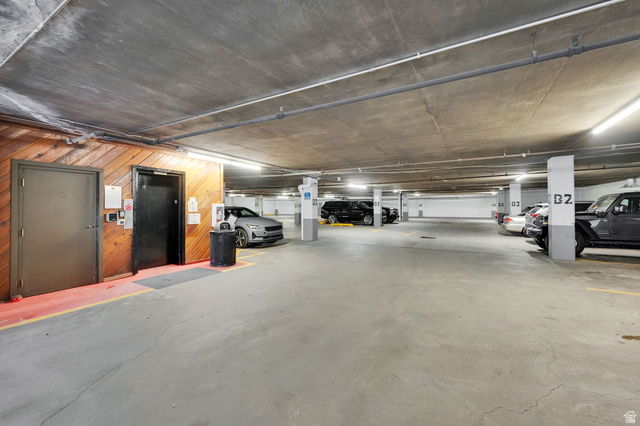 50 Shadow Ridge Road, Unit 4209 Park City, UT 84060 - Photo 32 of 50 Covered parking garage with concrete flooring and ceiling, illuminated by overhead lighting, featuring marked parking spaces and clear structural columns