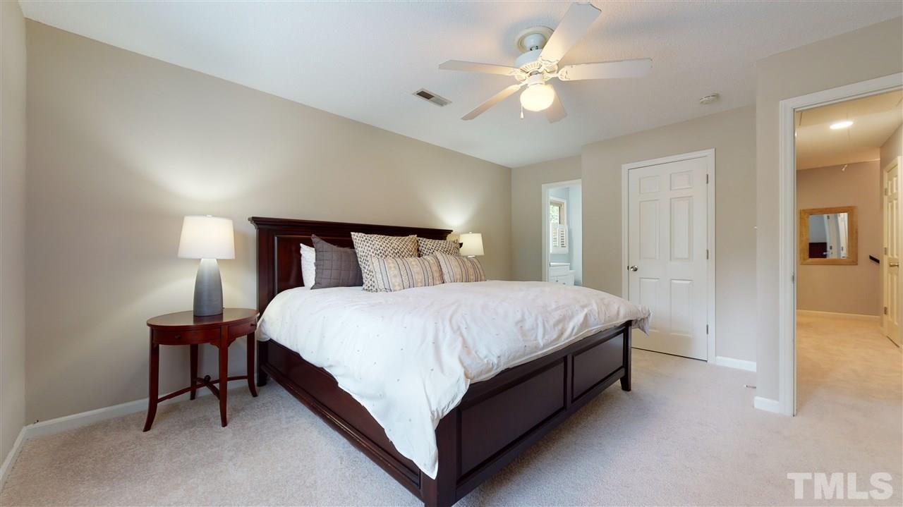 2104 Chrisdale Court Raleigh, NC 27607 - Photo 16 of 29 a bedroom with a bed and a ceiling fan