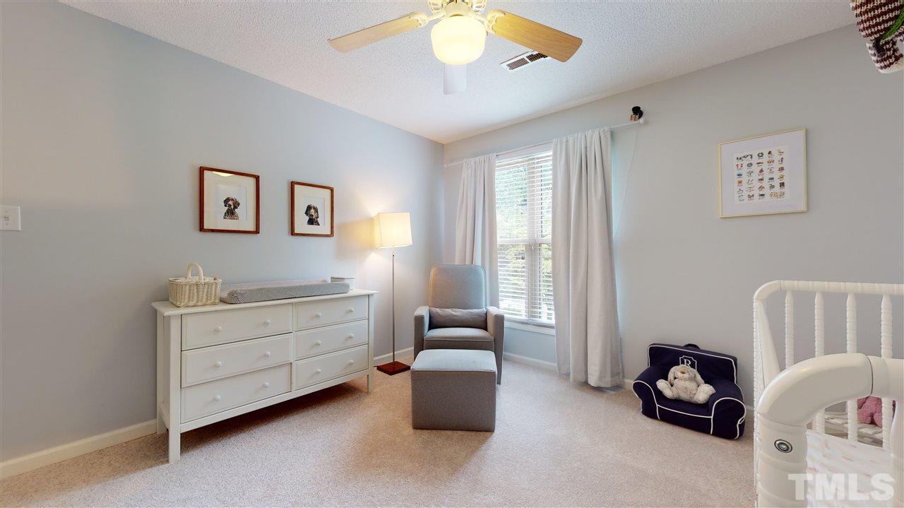 2104 Chrisdale Court Raleigh, NC 27607 - Photo 19 of 29 a room with furniture and a chair