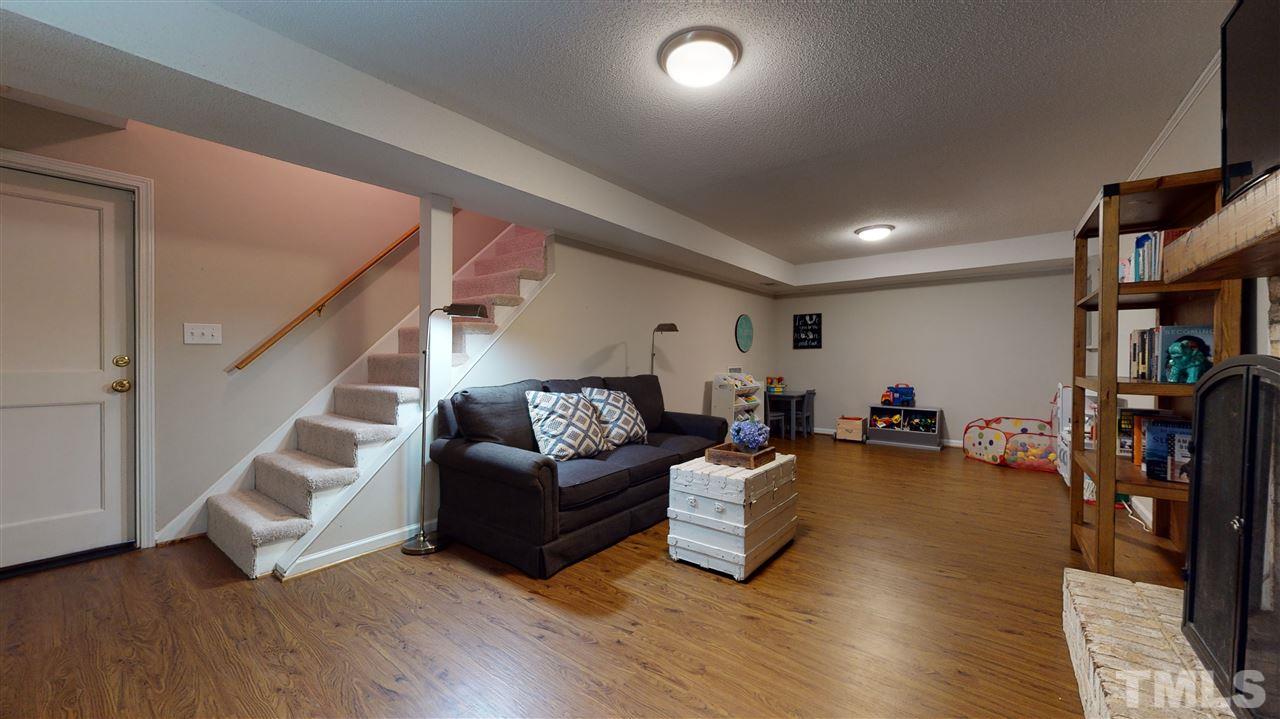 2104 Chrisdale Court Raleigh, NC 27607 - Photo 23 of 29 a living room with furniture and wooden floor