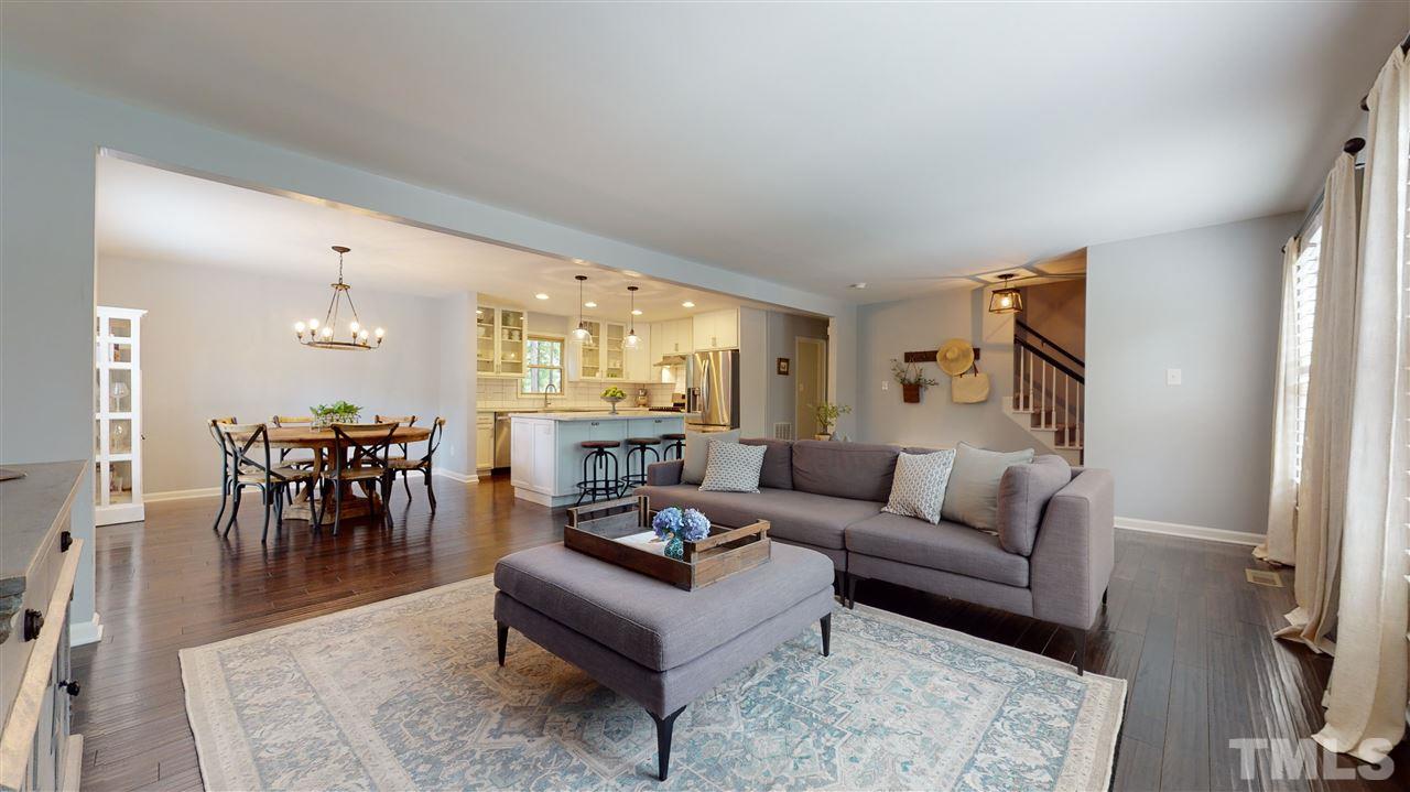 2104 Chrisdale Court Raleigh, NC 27607 - Photo 4 of 29 a living room with furniture and a dining table with kitchen view
