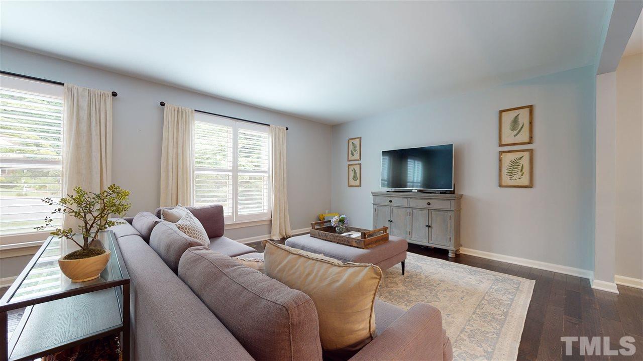 2104 Chrisdale Court Raleigh, NC 27607 - Photo 6 of 29 a bedroom with furniture and a flat screen tv