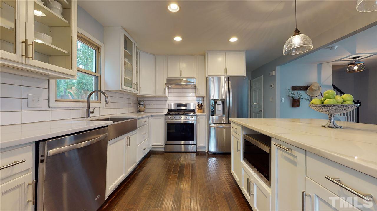 2104 Chrisdale Court Raleigh, NC 27607 - Photo 9 of 29 a kitchen with a sink dishwasher a stove and a refrigerator