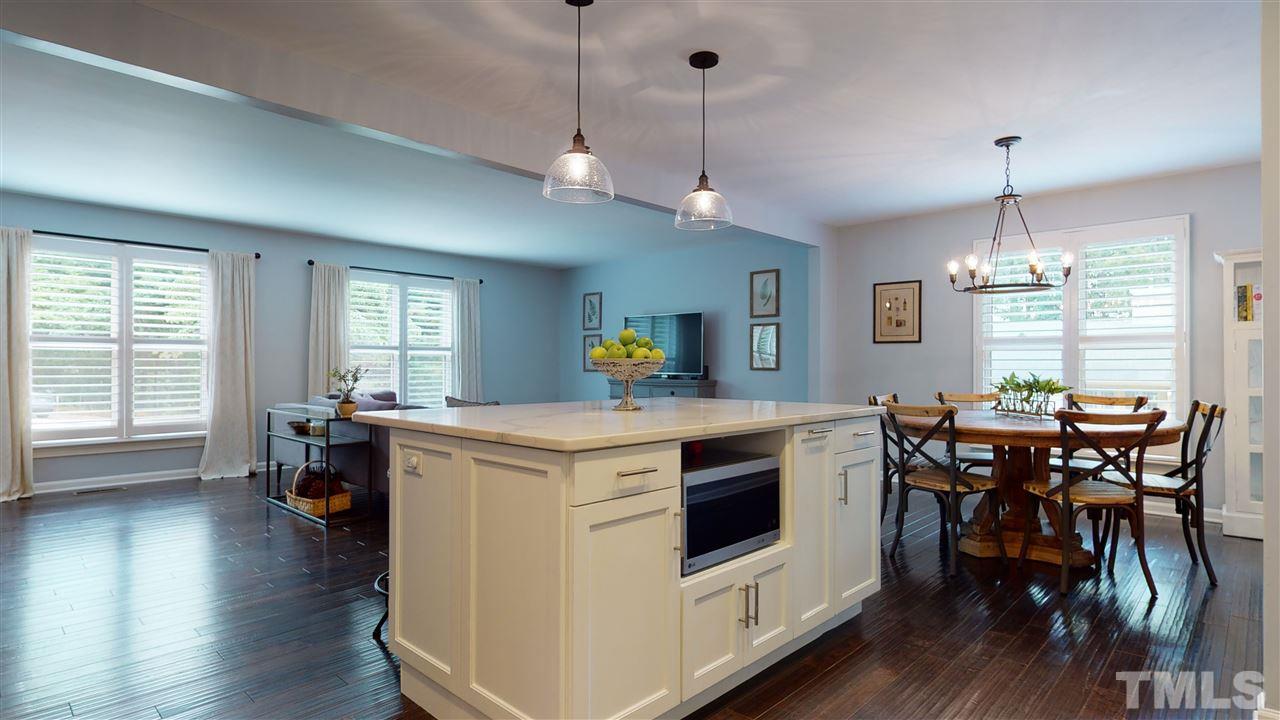 2104 Chrisdale Court Raleigh, NC 27607 - Photo 10 of 29 a kitchen that has a table chairs and wooden floor