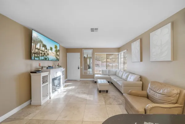 a view of a dining room with furniture and a chandelier