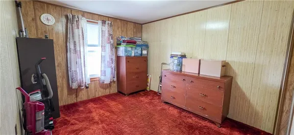 walk in closet with window and a mirror