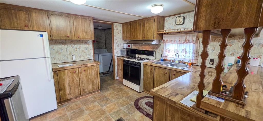 76 South Kings Creek Road Burgettstown, PA 15021 - Photo 5 of 15 a kitchen with stainless steel appliances granite countertop a refrigerator a stove and a sink