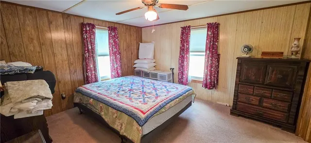 a living room with a bed and a dresser