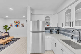 2747 Griffin Road, Unit 13 Fort Lauderdale, FL 33312 - Photo 17 of 37 a white refrigerator freezer sitting inside of a kitchen
