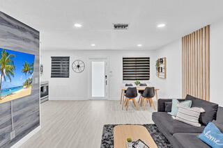 2747 Griffin Road, Unit 13 Fort Lauderdale, FL 33312 - Photo 20 of 37 a living room with furniture and a flat screen tv