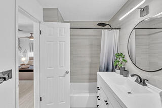 2747 Griffin Road, Unit 13 Fort Lauderdale, FL 33312 - Photo 25 of 37 a bathroom with a sink a shower and a mirror