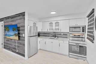 2747 Griffin Road, Unit 13 Fort Lauderdale, FL 33312 - Photo 28 of 37 a kitchen with stainless steel appliances granite countertop a refrigerator and stove