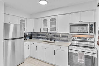 2747 Griffin Road, Unit 13 Fort Lauderdale, FL 33312 - Photo 30 of 37 a kitchen with appliances a sink and cabinets