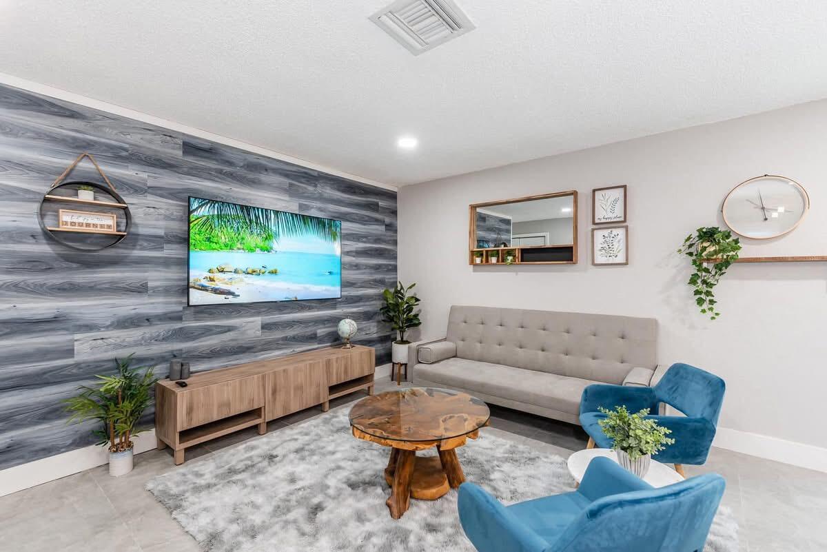 2747 Griffin Road, Unit 13 Fort Lauderdale, FL 33312 - Photo 35 of 37 a living room with furniture and a wooden floor
