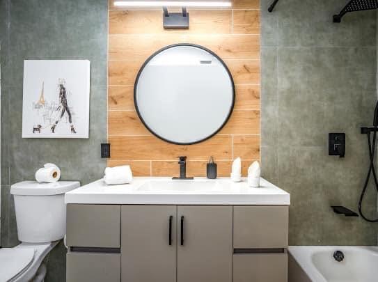 2747 Griffin Road, Unit 13 Fort Lauderdale, FL 33312 - Photo 9 of 37 a bathroom with a toilet a sink and a mirror