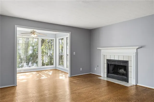 a view of an empty room with a fireplace and a window