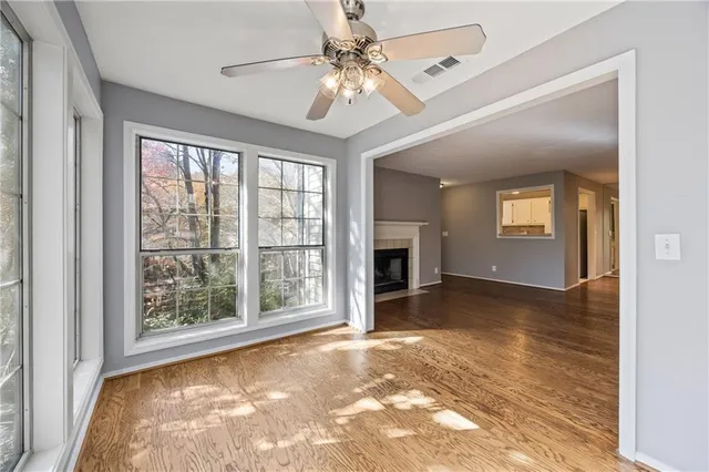 a view of a livingroom with a ceiling fan and window