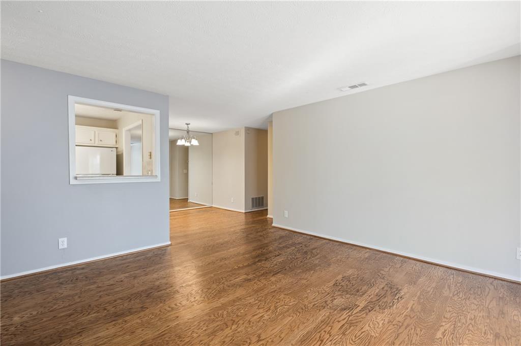 707 Gettysburg Place Atlanta, GA 30350 - Photo 14 of 40 a view of an empty room with wooden floor and a window