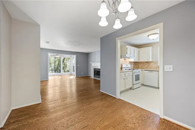 a view of a kitchen with a stove cabinets and wooden floor