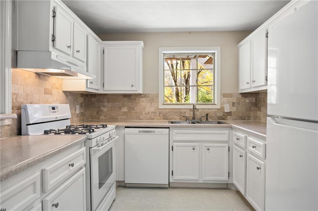 707 Gettysburg Place Atlanta, GA 30350 - Photo 17 of 40 a kitchen with cabinets appliances a sink and a window