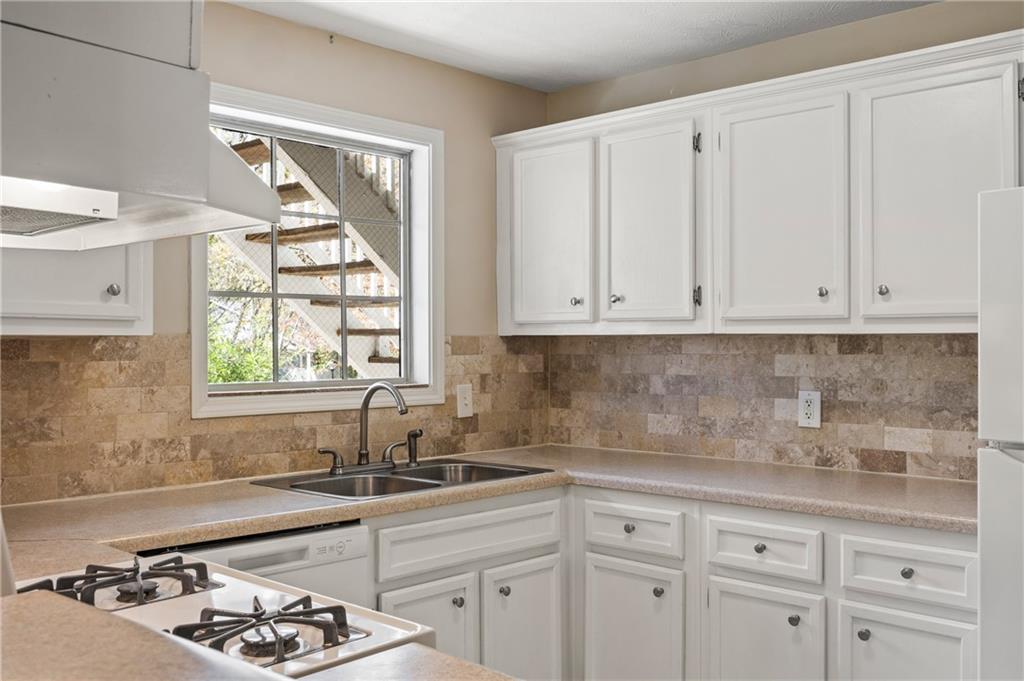 707 Gettysburg Place Atlanta, GA 30350 - Photo 19 of 40 a kitchen with white cabinets and a window