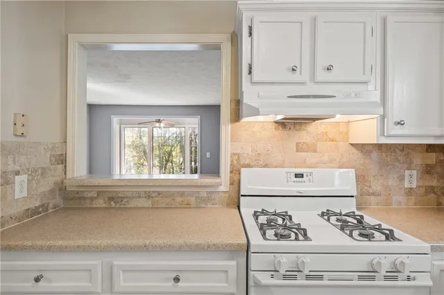 a view of kitchen with sink and cabinets