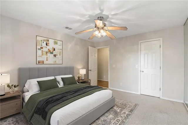 a bedroom with a large bed and a chandelier