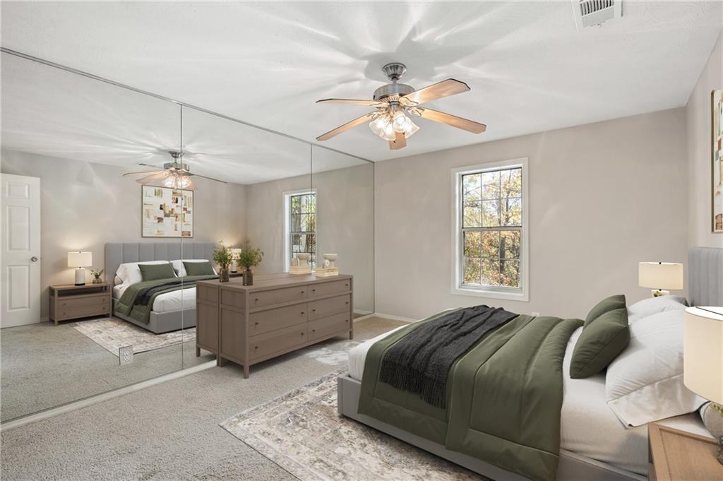 707 Gettysburg Place Atlanta, GA 30350 - Photo 22 of 40 a bed room with a bed and a chandelier