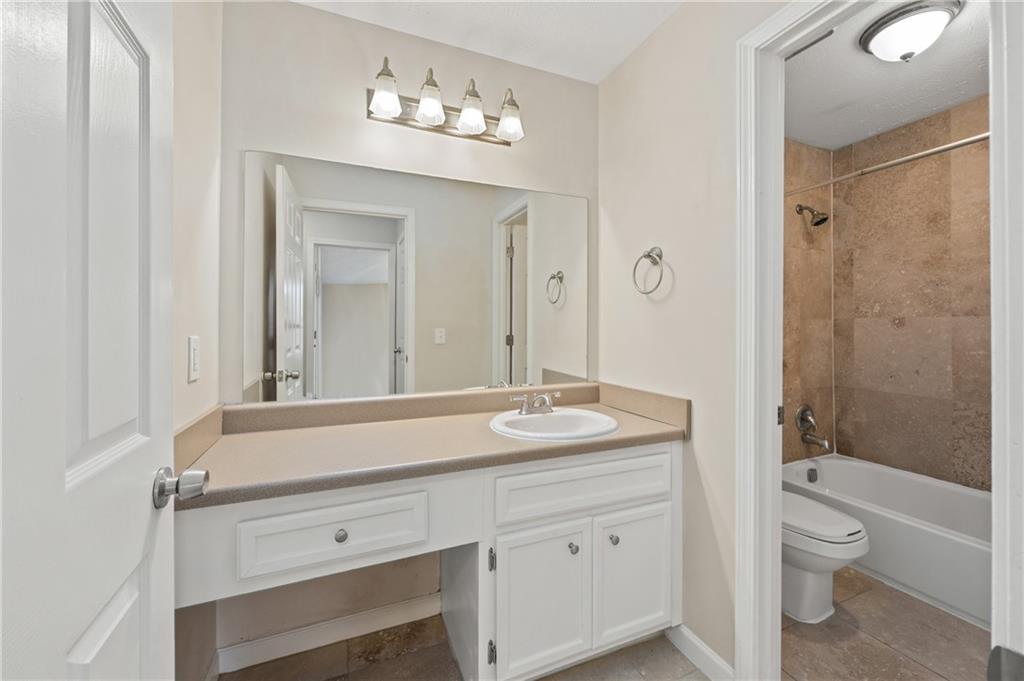 707 Gettysburg Place Atlanta, GA 30350 - Photo 25 of 40 a bathroom with a sink a toilet and shower