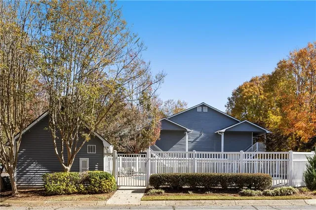 a tree in front of a brick building