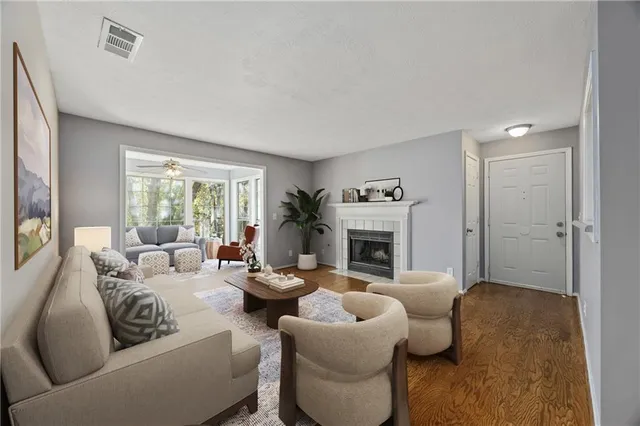 a living room with furniture fireplace and a window