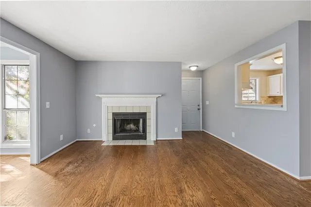 an empty room with windows and a fireplace