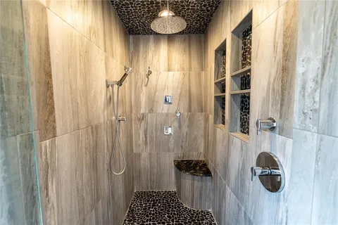 a view of a bathroom with shower and window