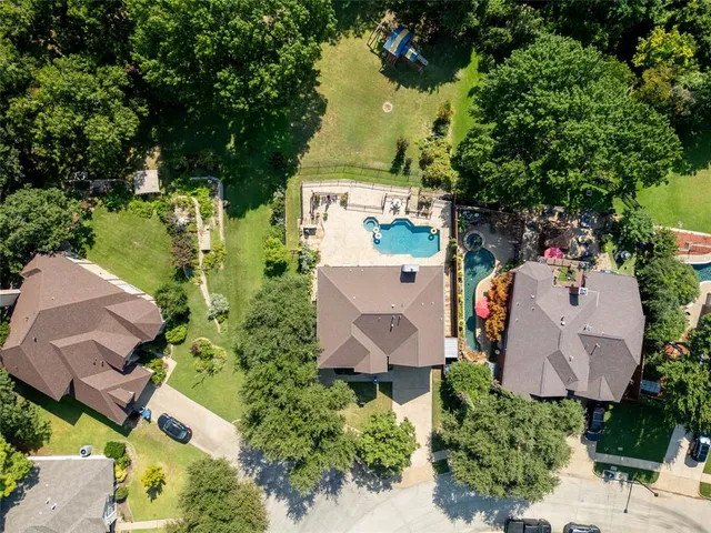an aerial view of a house with outdoor space and lake view
