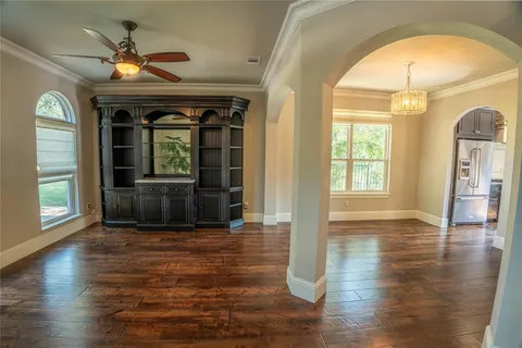 a view of empty room with a fireplace and wooden floor
